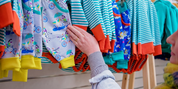 Image of a lady looking at a rail of Ducky Zebra clothes