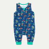 Blue organic cotton dungarees with a zip down the front and a repeat print of a cycling and walking frog and hippo. The dungarees have a green roll-down cuff.