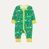 Baby zip-up sleepsuit with a green background and repeat print of a dog and hedgehog playing with a wheelbarrow and gardening together. The sleepsuit has a contrasting yellow zip, cuffs and chin guard.