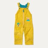 Mustard yellow kids cord dungarees with front zip and two big pockets - each with an appliqué. One is a highland cow, the other a king fisher.