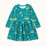 Teal Skater Dress with repeat print pattern of a highland cow, otter and king fisher rowing, wild swimming and exploring together. The dress has long sleeves and two big pockets.