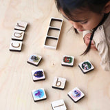 Child using The Phive's Phonics Tiles. She has spelt out the word CAR