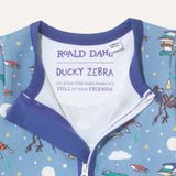 Close up of label on baby zip-up sleepsuit which has the Roald Dahl quote: "No book ever ends when it's full of your friends"