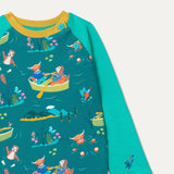 Close up of teal sweatshirt with a fun repeat print of a highland cow, otter and king fisher wild swimming and rowing. The sweatshirt has teal sleeves, a mustard yellow trim and two turquoise buttons on the shoulder.
