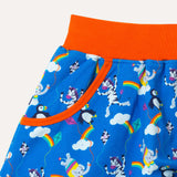 Organic cotton bright blue skort with repeat print pattern of a colourful elephant, zebra and puffin flying kites together. Image is a close up of one of the two deep pockets with an orange trim and an orange elasticated waistband