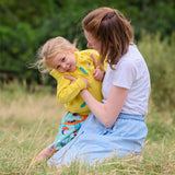Image of a child and mum hugging. The child is wearing a Ducky Zebra yellow hoodie and colourful skort.