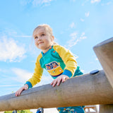 Girl at the top of a climbing frame wearing a colourful unisex jumper with an Appliqué of a fox and elephant driving a yellow campervan 