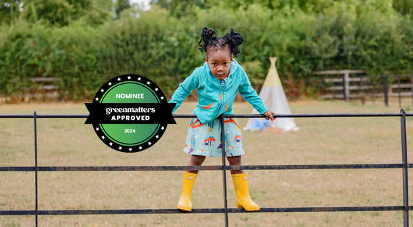 Image of girl wearing Ducky Zebra organic cotton clothes with Green Matters logo