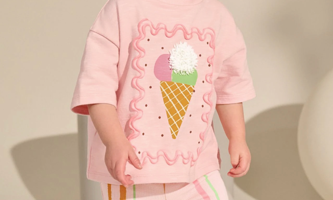 Image of a girl wearing a pink top with an ice cream on it