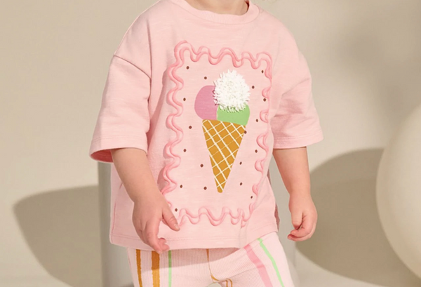 Image of a girl wearing a pink top with an ice cream on it