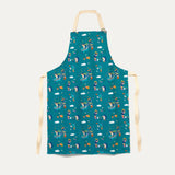 Ducky Zebra Teal Adult Apron, with Adjustable buckle strap. The apron has a repeat print pattern of a dog and hedgehog gardening and playing in a wheelbarrow