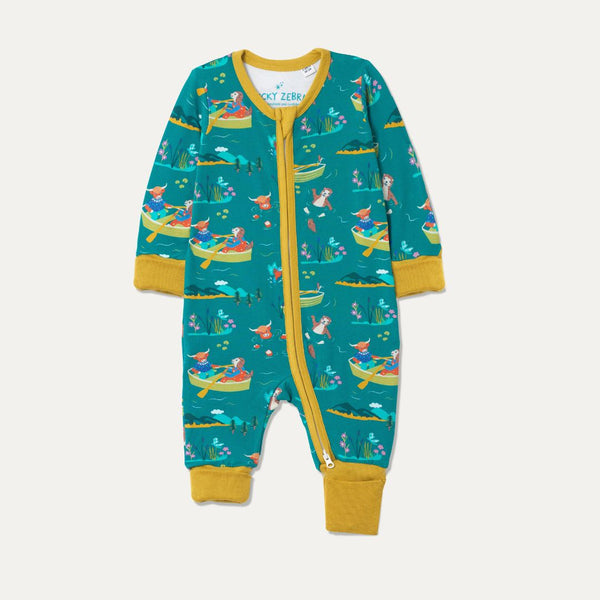 Teal Baby Sleepsuit with fun repeat print pattern of a highland cow and otter rowing and wild swimming. The sleepsuit has contrasting mustard yellow cuffs rolled up and a full length zip. 
