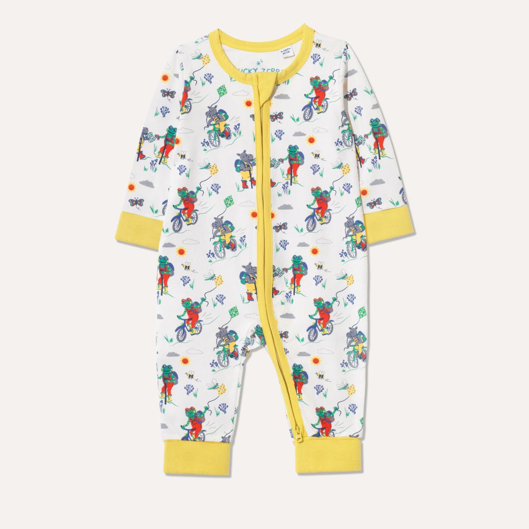 Cream Unisex Baby Sleepsuit with a hippo and frog walking and cycling on the Yorkshire Moors - made by Ducky Zebra