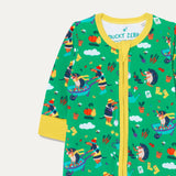 Close up of unisex baby zip-up sleepsuit with a green background and repeat print of a dog and hedgehog playing with a wheelbarrow and gardening together. The sleepsuit has a contrasting yellow zip, cuffs and chin guard.