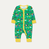Baby zip-up sleepsuit with a green background and repeat print of a dog and hedgehog playing with a wheelbarrow and gardening together. The sleepsuit has a contrasting yellow zip, cuffs and chin guard.   