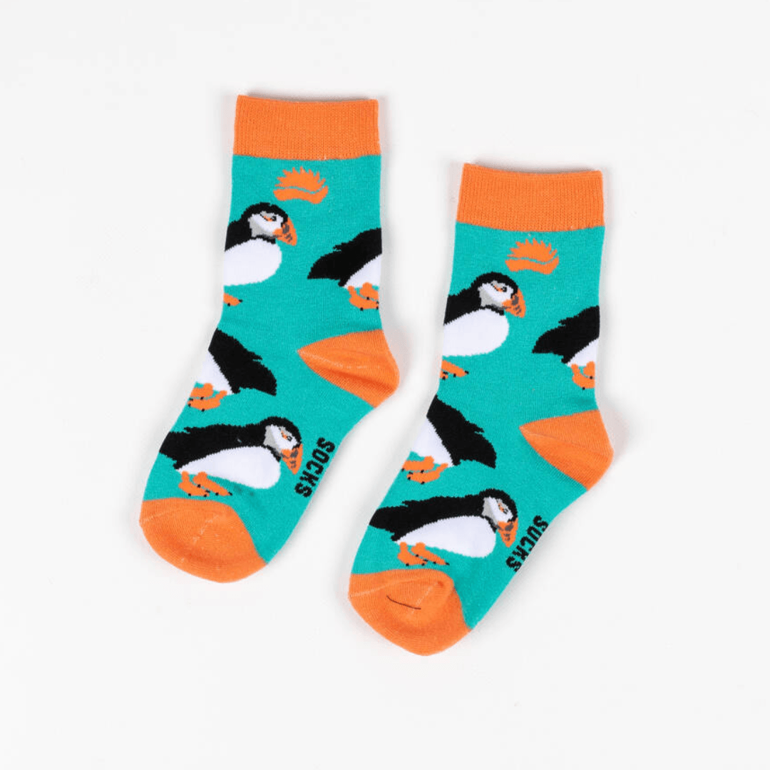 Pair of children's socks with turquoise background, orange trim and repeat puffin print