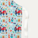 Close up of cotton children's apron with a fun farmyard print - with sheep and big driving their tractor and looking after the bees