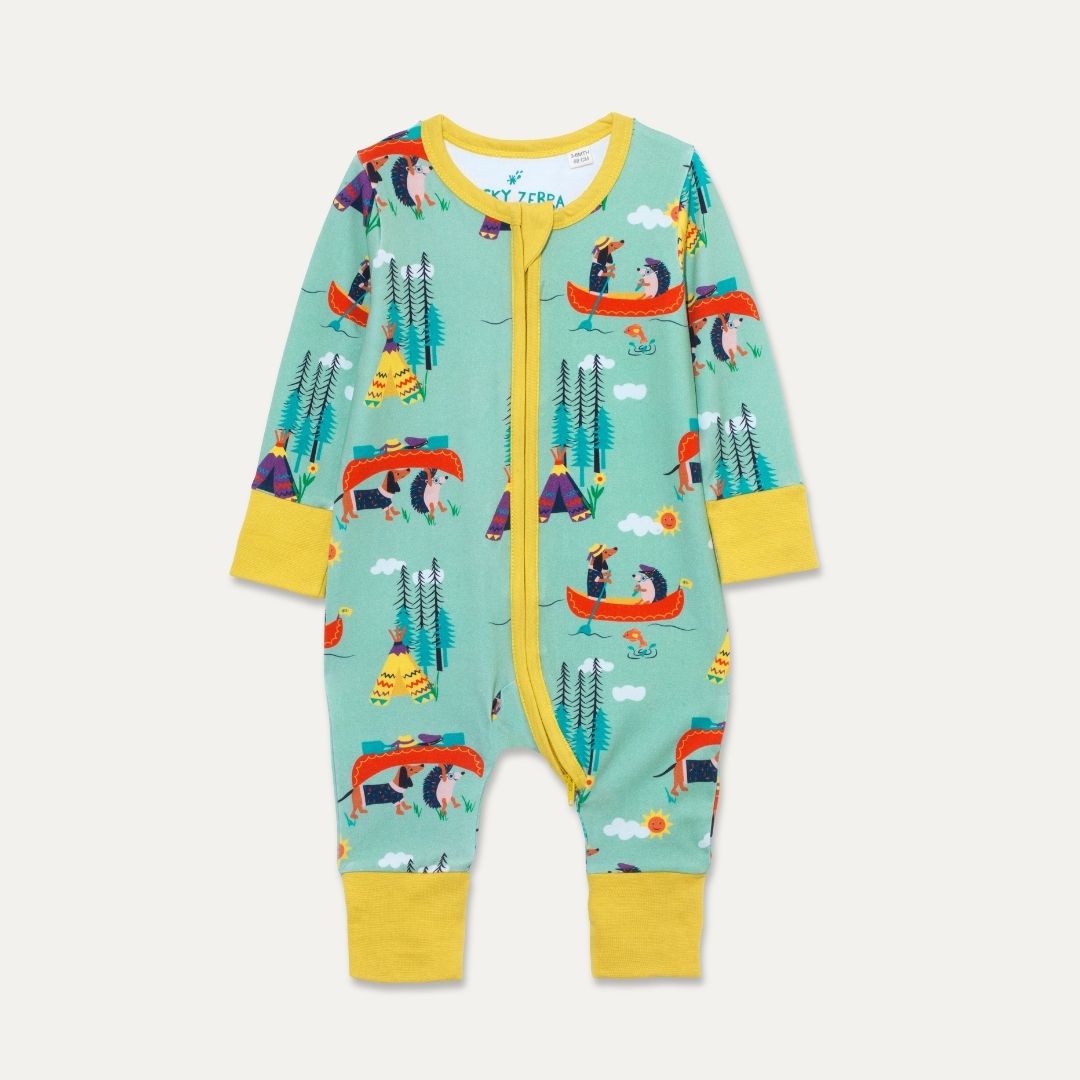 Green unisex baby sleepsuit with a repeat print pattern of a dog and hedgehog canoeing. The baby romper has a contrasting yellow 2-way zip and cuffs. 