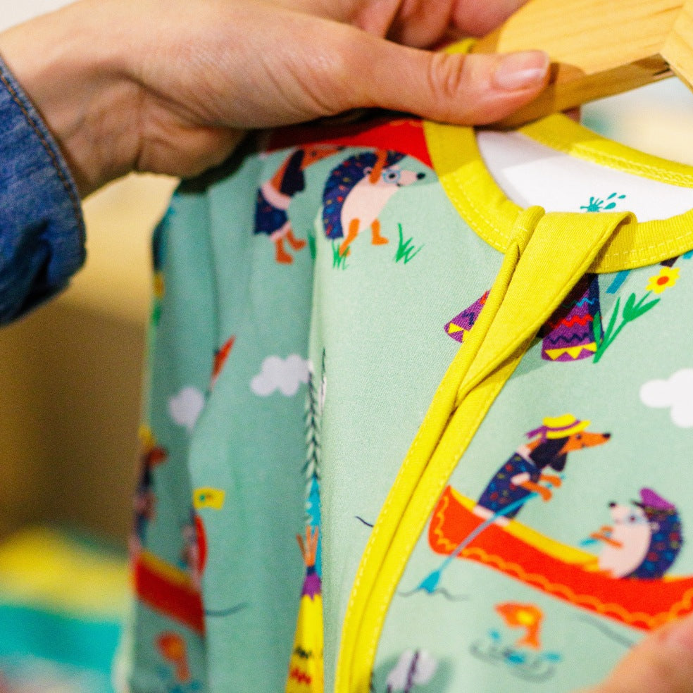 Children's outfit with colorful animal patterns on a hanger