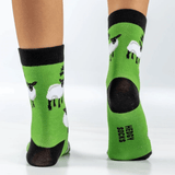 Back of a child, wearing green Hedgy sheep socks