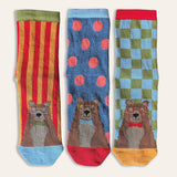 Pack of three children's socks with bears on each. The socks are brightly coloured with stripes, cheques and spots.