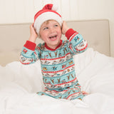 Child wearing Roald Dahl Pyjamas, with a red Christmas hat