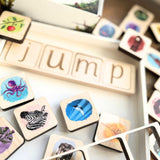 Wooden phonics tiles joined together to spell JUMP 