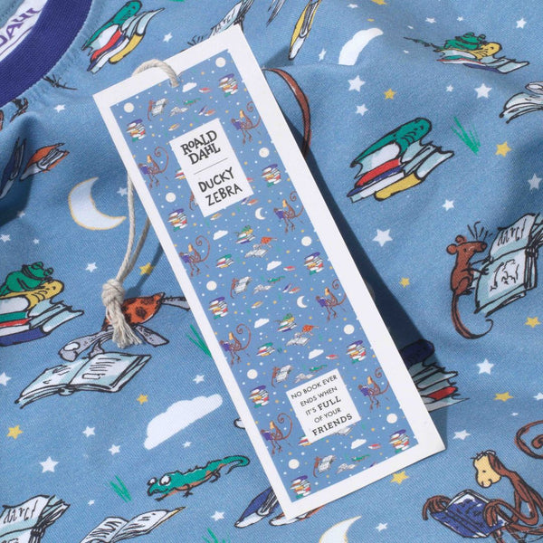 Close up of Roald Dahl x Ducky Zebra kids pyjamas, with a bookmark swing tag stating "No book ever ends when it's full of your friends"