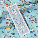 Close up of organic cotton PJs, showing a bookmark swingtag and characters from the Giraffe and the Pelly and Me leaping from the pages of a book