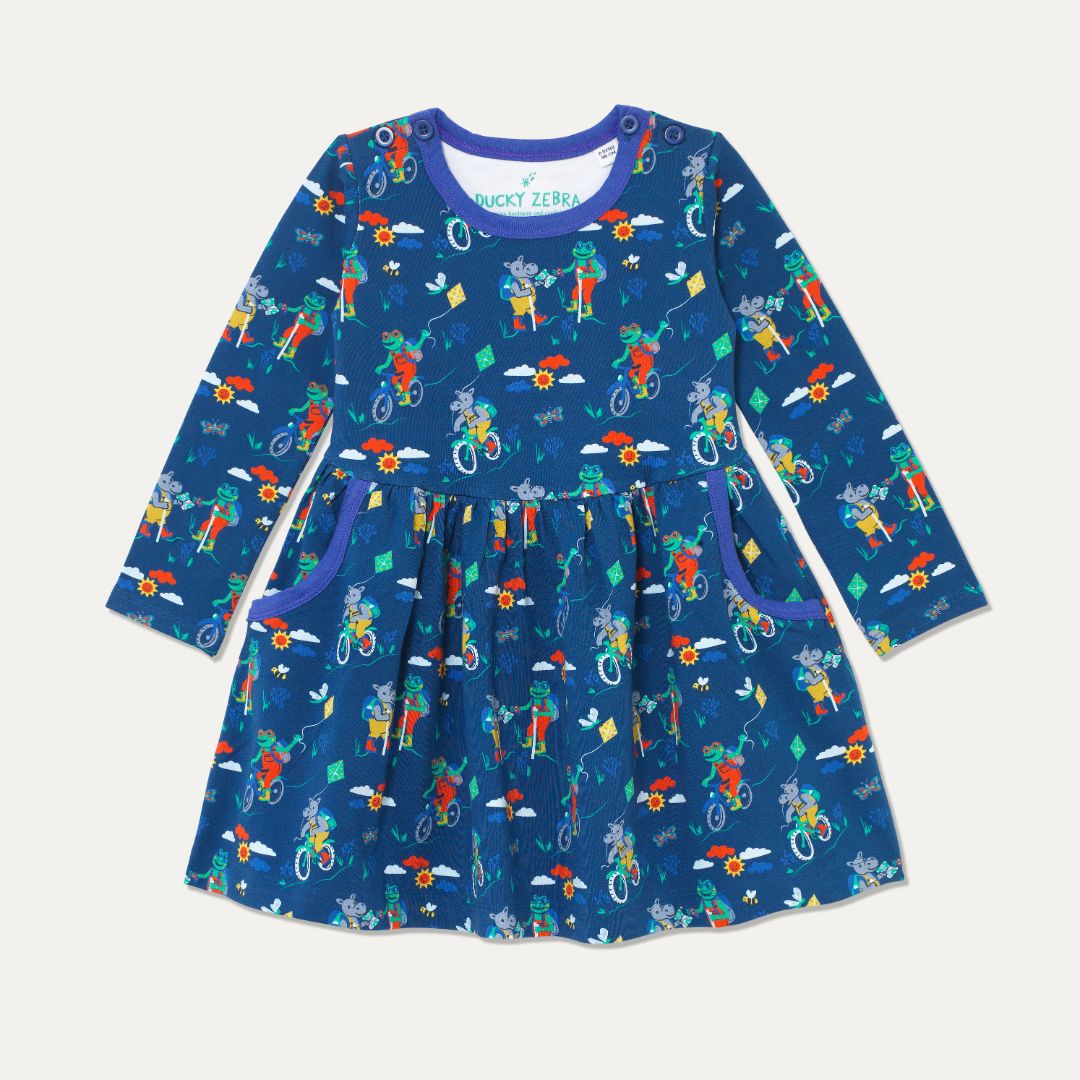 Navy blue skater dress with purple trim and repeat print of a frog and hippo cycling and walking on the Yorkshire Moor