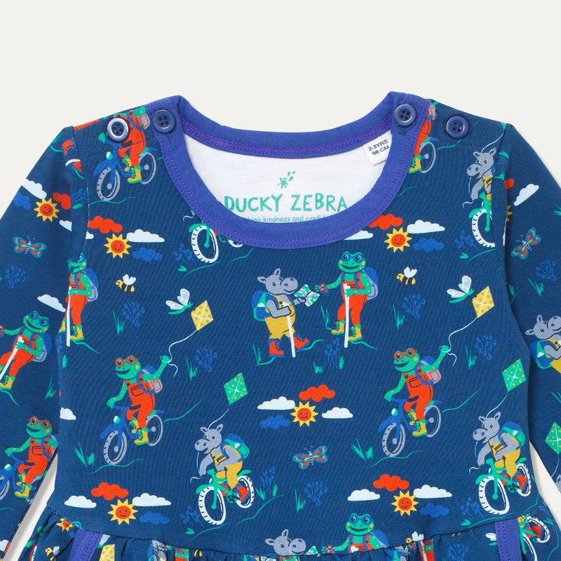 Close up of buttons on neck of navy blue skater dress with hippos, frogs and bees - and a purple trim