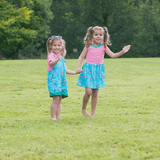 Two children waving at the camera wearing Ducky Zebra 'under the sea' nautical themed dress and dungarees