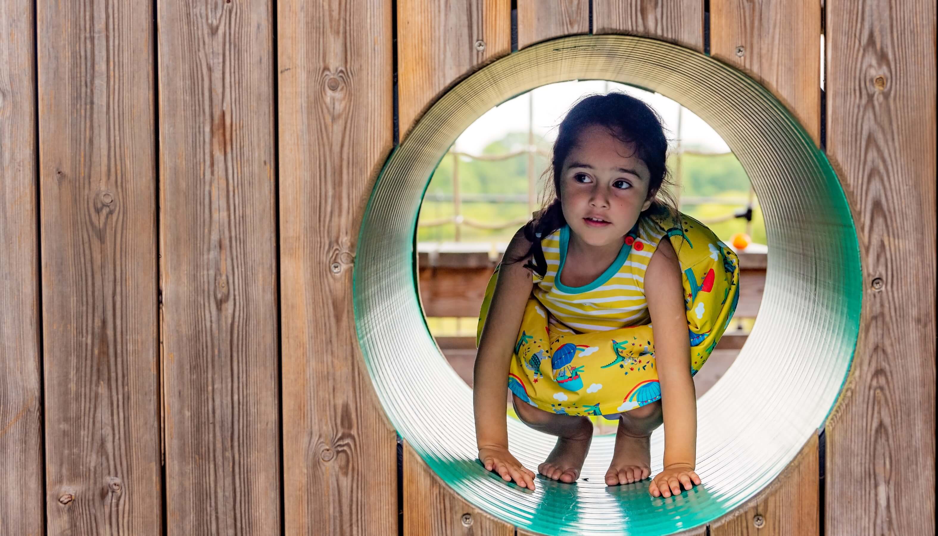 Girl at playground wearing yellow hot air balloon Ducky Zebra dress