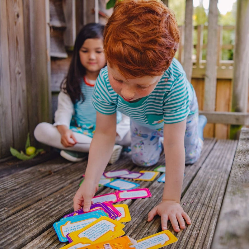 Image of two children looking through the Happy Confident Company Conversation Cards