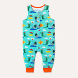 Image of a sleeveless unisex baby romper with a turquoise background and colourful repeat print pattern of an elephant and crocodile playing at the seaside. The image shows the front of the romper, including 4 flame orange poppers and flame orange roll up leg cuffs