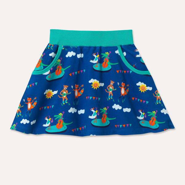 Image of a Ducky Zebra kids skirt with a Festival repeat print pattern, including a double base playing crocodile, saxophone playing duck, maraca shaking fox and ukulele playing cheetah. Full shot of the skirt, displaying two deep pockets with turquoise trim and a turquoise elasticated waistband
