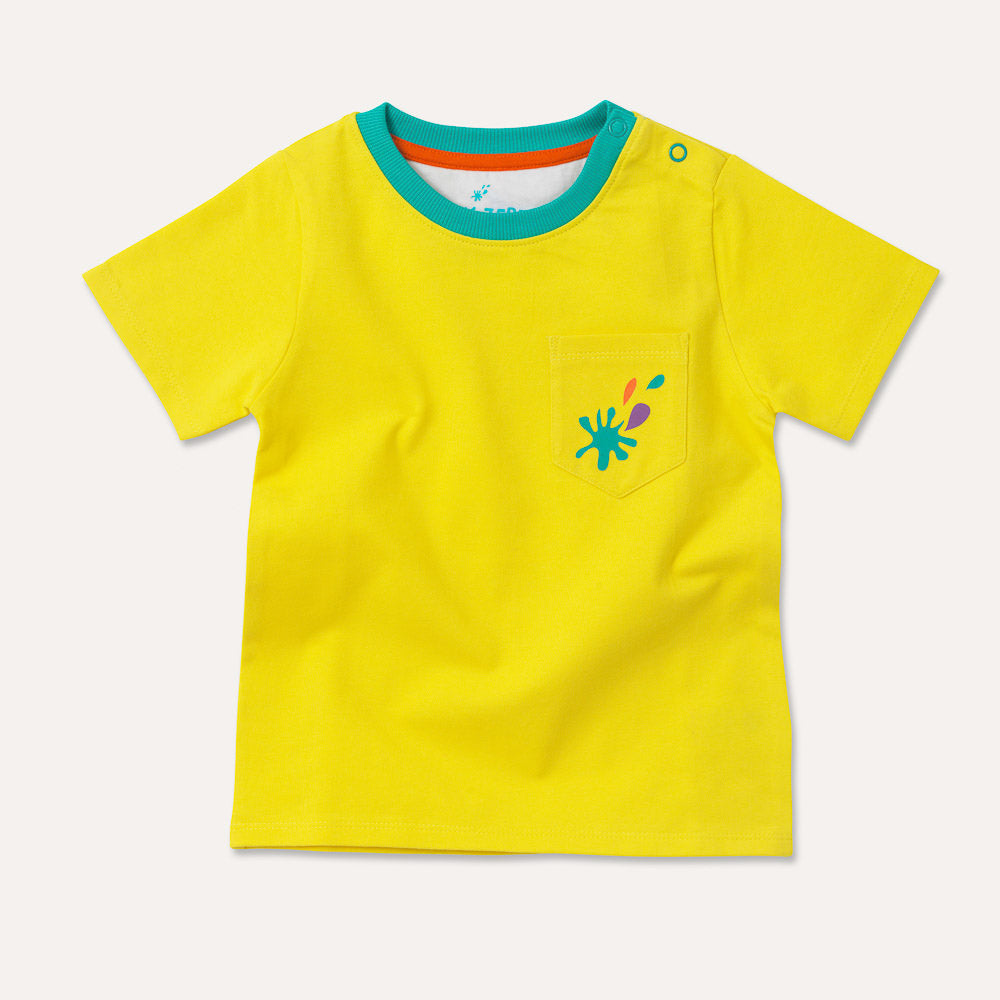 Image of a yellow baby and kids t-shirt with a turquoise neck ribbing, two turquoise poppers on the shoulder and a yellow pocket with a turquoise, purple and orange splash print