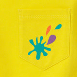 Image of a yellow baby and kids t-shirt, focusing on the yellow pocket with a turquoise, purple and orange splash print