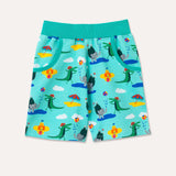 Brightly coloured children's shorts with a turquoise background and repeat print pattern of a smiling crocodile and elephant playing at the seaside. Front shot of the shorts, displaying two deep pockets and an elasticated turquoise waistband