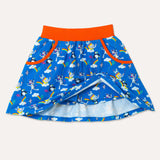 Organic cotton bright blue skort with repeat print pattern of a colourful elephant, zebra and puffin flying kites together. Image shows the full skort including two deep pockets with an orange trim and an orange elasticated waistband
