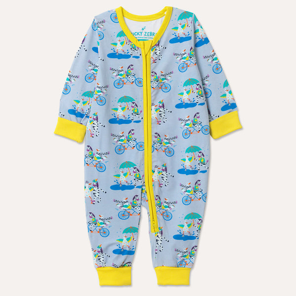 Image of a long sleeve zip-up unisex baby romper with a light grey background and colourful repeat print pattern of a duck and zebra splashing in a puddle, riding a bicycle and running a three legged race. The images shows bright yellow cuffs, trim and a two way zip