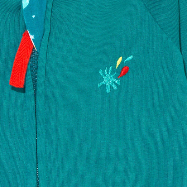 Close up of Ducky Zebra teal hoodie with red zipper and embroidered splash 'power button' on the chest - made from turquoise, red and yellow thread.
