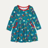 Image of a long sleeve teal dress with a red trim and two big pockets. The dress has an elephant, zebra, duck and puffin dressed up in space suits and traveling in rockets through space.