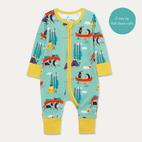 Image of unisex Ducky Zebra baby romper, with a light green background and repeat print pattern of a dog and hedgehog rowing and carrying their boat. The romper has a contrasting yellow 2-way zip and cuffs. We see the cuffs both rolled up and rolled-down.