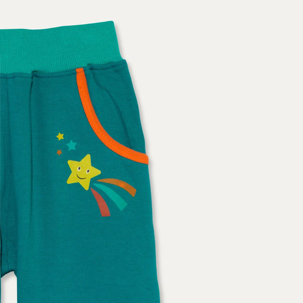 Close up image of Ducky Zebra teal trousers, focusing on one of the pockets with an orange trim - and a fun star print immediately below.