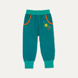 Colourful Ducky Zebra Joggers with Teal background and orange pocket trim. There's a yellow star print below one of the two pockets.
