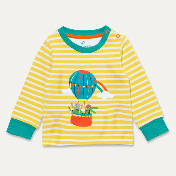 Image of a Ducky Zebra long-sleeve t-shirt. The t-shirt has yellow and white stripes with a print of a crocodile and elephant enjoying a hot air balloon ride together. There are two orange poppers on one of the shoulders. 