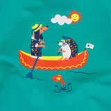  Close up of the Ducky Zebra turquoise t-shirt, with a focus on the print of the hedgehog and sausage dog rowing a boat.